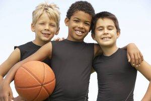3 boys holding a basketball